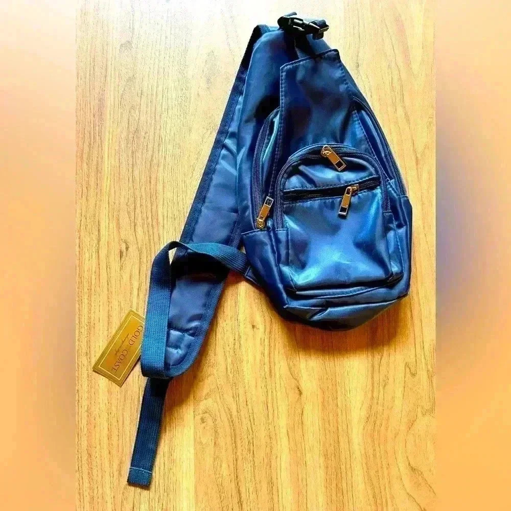 Gold Coast navy sling bag w several zip pockets, travel